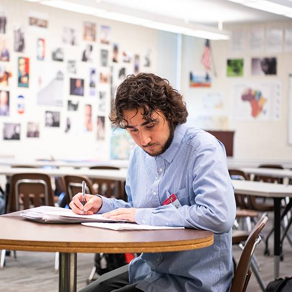 Male student working on an assignment