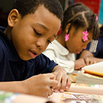 Little boy and girl working on school work.