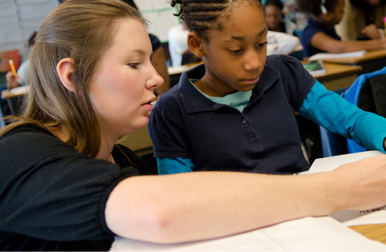 teacher helping student